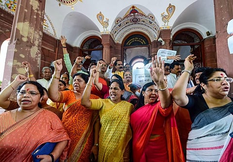BJP MPs shout slogans during a protest against Congress leader Adhir Ranjan Chowdhury's remarks on President Droupadi Murmu, at Parliament House, in New Delhi. (Photo | PTI)