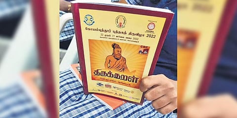 Thirukkural distributed during the book reading event. The saint-composer is shown as wearing saffron.