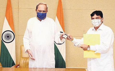 Finance Minister Niranjan Pujari presenting the digital budget document to Chief Minister Naveen Patnaik on Saturday. (Photo | Express)