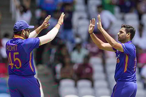 India's Bhuvneshwa Kumar celebrates with Rohit Sharma, the dismissal of West Indies' Shamarh Brooks during the T20 cricket match at Brian Lara Cricket Academy in Tarouba on Friday. (Photo | PTI)