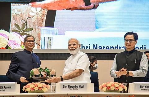 Prime Minister Narendra Modi receives a memento from Chief Justice of India N.V. Ramana during the inaugural session of First All India District Legal Services Authorities Meet. (Photo | PTI)