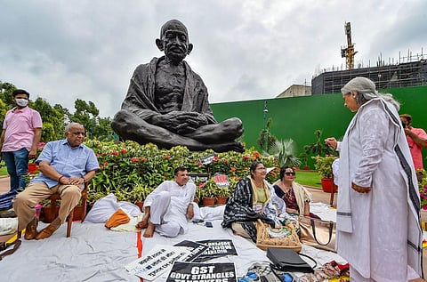 Samajwadi Party MP Jaya Bachchan interacts with opposition MPs protesting against the Union Government, near the statue of Mahatma Gandhi at Parliament House. (Photo | PTI)