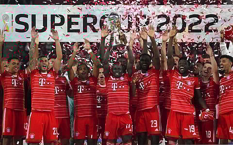 Bayern's Sadio Mane, front center, lifts the trophy as he and his teammates celebrate winning the German Supercup 2022 soccer match. (Photo | AP)