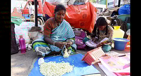 Flower seller R Alamelu and her granddaughter in Chennai. (Photo| R Satish Babu, EPS)