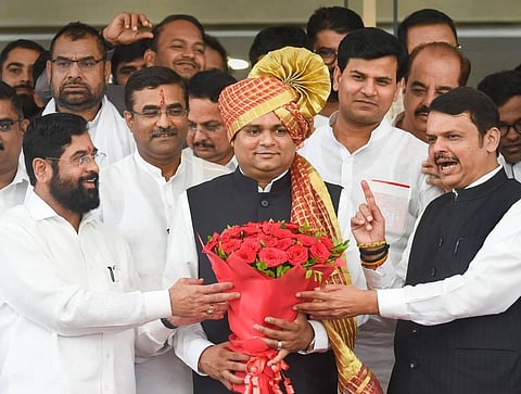Newly-elected Maharashtra Assembly Speaker Rahul Narvekar being presented a bouquet by Maharashtra CM Eknath Shinde and Deputy CM Devendra Fadnavis. (Photo | PTI)