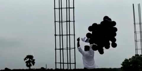 A Congress activist releases black balloons near Gannavaram airport. (Photo| EPS)