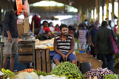 A vender waits for customers at a vegetable market place in Colombo, Sri Lanka, Friday, June 10, 2022.(Photo | AP)