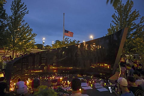 Dozens of mourners gather for a vigil near Central Avenue and St. Johns Avenue in downtown Highland Park in US on July5,2022(Photo | AP)