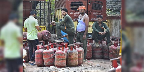: Workers arrange LPG cylinders at a godown in New Delhi, Wednesday, July 6, 2022.(Photo | PTI)