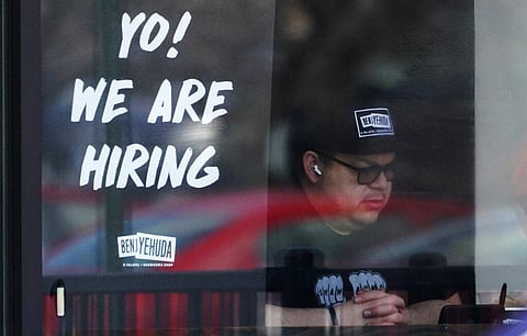 A hiring sign is displayed at a restaurant in Schaumburg. (Photo | AP)
