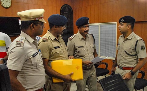 Chhattisgarh Police personnel give a notice to the local police in the Sector 20 Police Station regarding the arrest of Zee News anchor Rohit Ranjan, in Noida. (Photo | PTI)