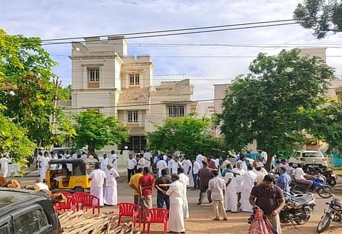 AIADMK cadre and supporters gather outside the residence of former Minister R Kamaraj at Mannargudi in Tiruvarur district where DVAC police officials are conducting a raid in connection with dispropor
