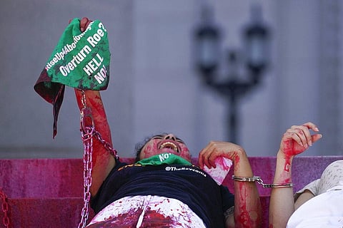 Abortion-rights activists chant after handcuffing themselves to the front steps of Los Angeles City Hall. (Photo | AP)
