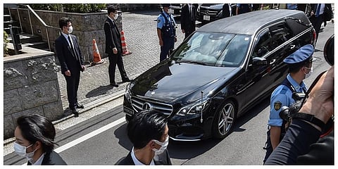 A hearse transporting the body of former Japanese prime minister Shinzo Abe arrives at his residence in Tokyo. (Photo | AFP)