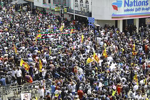 Protesters carrying Sri Lankan flags gathered outside the president's office in Colombo, Sri Lanka. (Photo | AP)