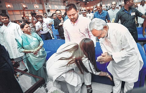 Nitish Kumar with Deputy Chief Minister Tejashwi Yadav and his wife during the swearing-in ceremony atthe Raj Bhavan in Patna on Wednesday. (Photo | PTI)