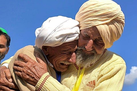 Indian Sika Khan (right) embracing his elder brother Sadiq Khan from Pakistan near the India-Pakistan border, on January 12, 2022. (Photo | AFP)