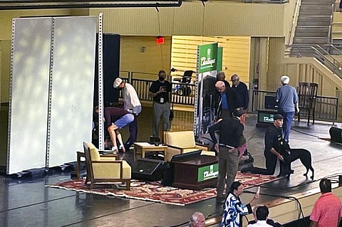 Author Salman Rushdie, behind screen left, is tended to after he was attacked during a lecture, Friday, Aug. 12, 2022, at the Chautauqua Institution in Chautauqua. (Photo | AP)