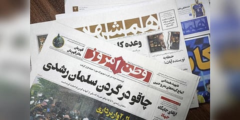 The front pages of the Aug. 13 edition of the Iranian newspapers, Vatan-e Emrooz, front, with title reading in Farsi: 'Knife in the neck of Salman Rushdie,' and Hamshahri, rear, with title: 'Attack on