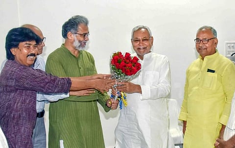 Bihar Chief Minister Nitish Kumar being greeted by CPI General Secretary Dipankar Bhattacharya during a meeting at his official residence. (Photo | PTI)