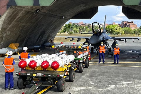 Military personnel stand next to Harpoon A-84, anti-ship missiles, air-to-air missiles prepared for a weapon loading drills in front of a F16V fighter jet at Hualien Airbase(AP)