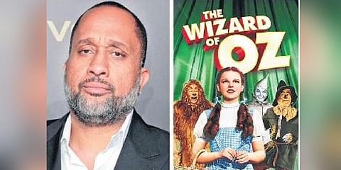 Kenya Barris and the poster of The Wizard of Oz