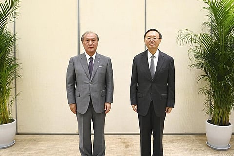 Yang Jiechi, right, director of the Office of the Foreign Affairs Commission of the CPC Central Committee and Akiba Takeo, head of Japan's National Security Secretariat (Photo | AP)