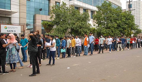Students wait in a queue to appear in Common University Entrance Test (CUET), outside a centre, in Noida, Wednesday, Aug 17, 2022. (Photo | PTI)