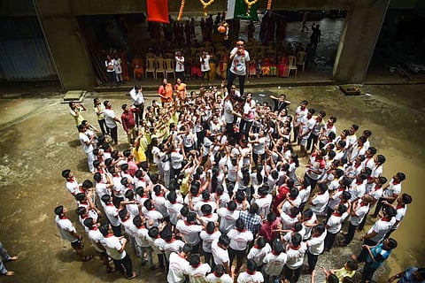 Students form a human pyramid to break the 'dahi handi' during 'Janmashtami' festival celebrations, at New Bombay City School in Navi Mumbai. (Photo | PTI)