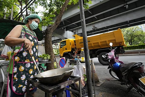Street food vendor Warunee Deejai cooks lunch for customers in Bangkok. In the six months since Russia invaded Ukraine, the fallout from the war has had huge effects on the global economy. (Pic | AP)