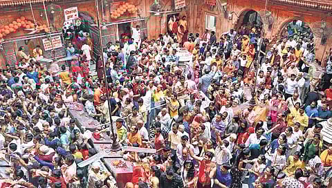Devotees gather to pray to Lord Krishna at Shri Bankey Bihari temple in Mathura on Saturday. Two people died due to suffocation at the temple on Friday night. | PTI