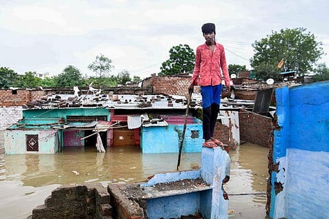A young man at a submerged residential area following heavy monsoon rains, in Bhopal, Tuesday, Aug. 23, 2022. (Photo | PTI)