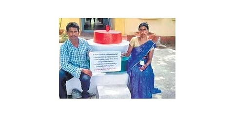 The tribal couple stages a protest with a placard on Tuesday