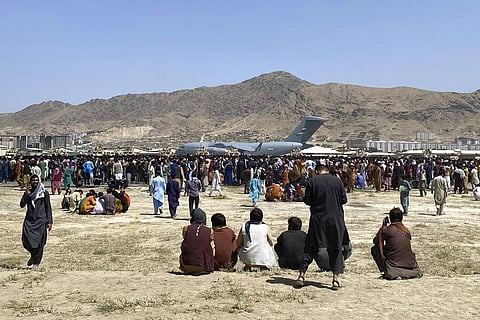 Hundreds of people gather near a U.S. Air Force C-17 transport plane at the perimeter of the international airport in Kabul, Afghanistan(File photo | AP)