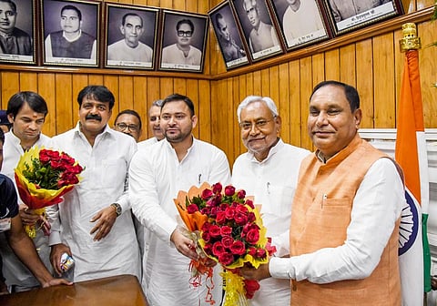Bihar Chief Minister Nitish Kumar and Deputy CM Tejashwi Yadav greet acting Speaker Maheshwar Hazari during special session of Bihar Legislative Assembly, in Patna. (Photo | PTI)