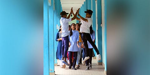 Two students of Chalai Government HSS welcome the girl students | Express