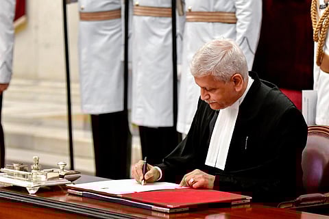 Justice Uday Umesh Lalit signs the register after his swearing-in ceremony as Chief Justice of India at Rashtrapati Bhavan in New Delhi. (Photo | PTI)