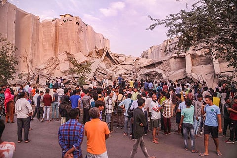People look at the debris of the demolished Supertech twin towers, in Noida, Sunday, Aug. 28, 2022. (Photo | PTI)