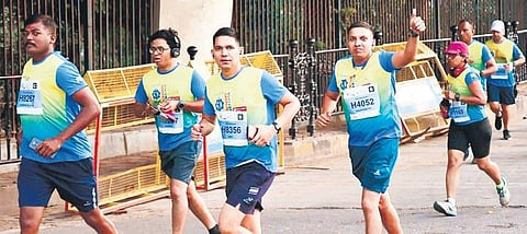 People take part in the 11th edition of the NMDC Hyderabad Half Marathon on Sunday