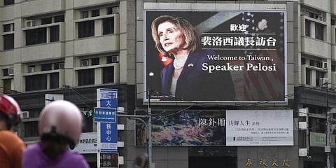 People walk past a billboard welcoming U.S. House Speaker Nancy Pelosi, in Taipei, Taiwan, Wednesday, Aug 3, 2022.(Photo | AP)