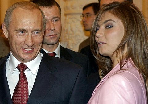President Vladimir Putin, left, speaks with gymnast Alina Kabaeva at a Kremlin banquet in Moscow, Russia.(File photo | AP)