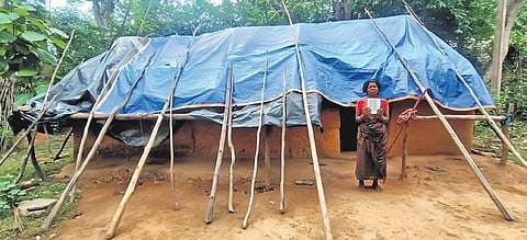 Chandamoni of Govindchandrapur in front of her tarpaulin covered house | Express