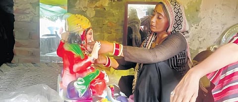An artisan giving a final touch to Lord Ganesha’s idol ahead of the festival. (Photo | Express)