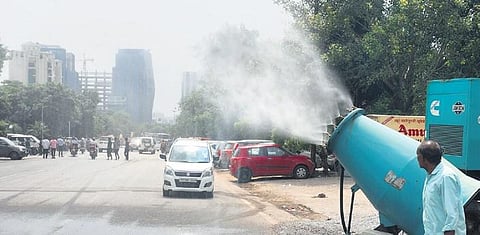 An anti-smog gun sprays water to wash off concrete dust on Monday.(Photo | Express)