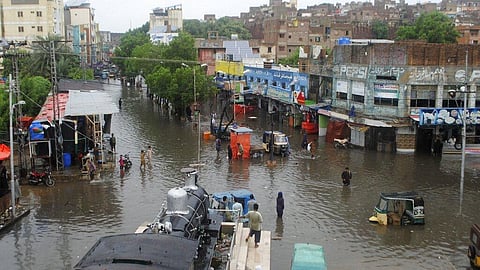 People navigate through flooded roads after heavy monsoon rains in Pakistan.