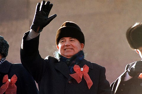 Soviet leader Mikhail Gorbachev waves from the parade review stand of the Lenin Mausoleum on Nov. 7, 1987 in Moscow' s Red Square during the 70th anniversary of the Russian Revolution. (Photo | AP)