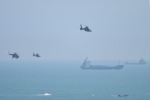 Chinese military helicopters fly past Pingtan island, one of mainland China's closest point from Taiwan, in Fujian province on August 4, 2022. (Photo | AFP)