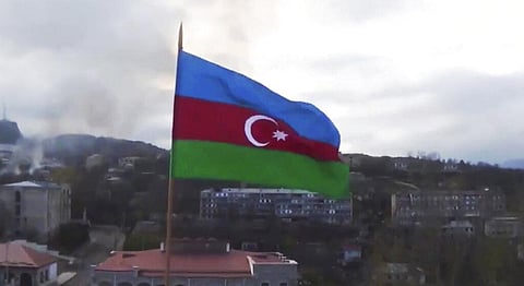 Azerbaijan's national flag with the city of Shushi in the background, in the separatist region of Nagorno-Karabakh. (Photo | AP)