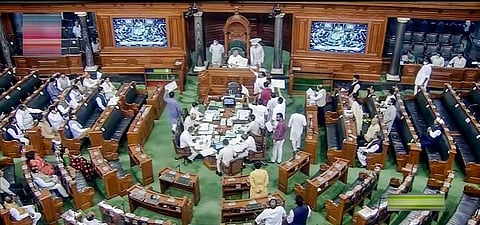 Opposition members stage a protest in the well of the Lok Sabha during Monsoon Session of Parliament, in New Delhi. (File Photo | PTI)