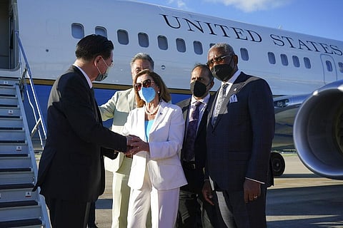 Taiwan's Foreign Minister Joseph Wu, left, speaks with U.S. House Speaker Nancy Pelosi as she prepares to leave in Taipei, Taiwan. (Photo | AP)